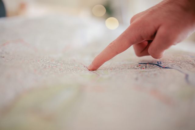 open map with a pointed finger