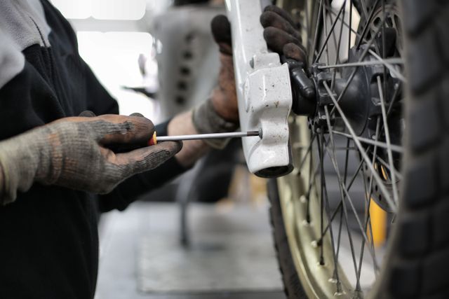 man changing a motorcycle tyre