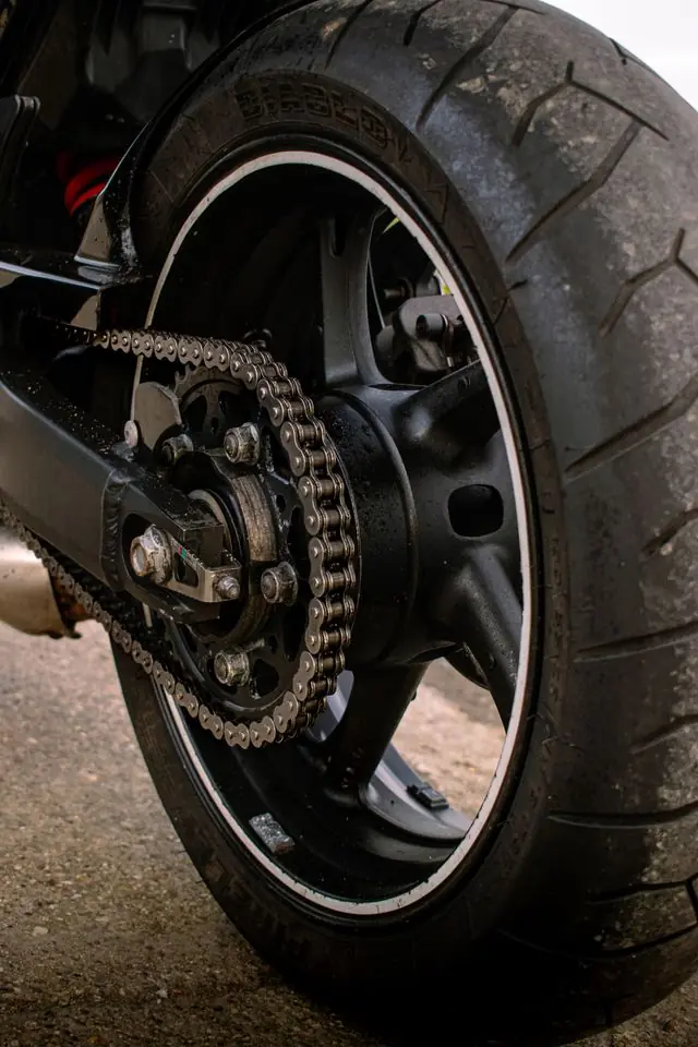 Close-up of a motorcycle's rear chain and wheel