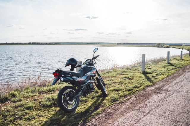 A trail motorcycle parked on a chalk byway in the English countryside