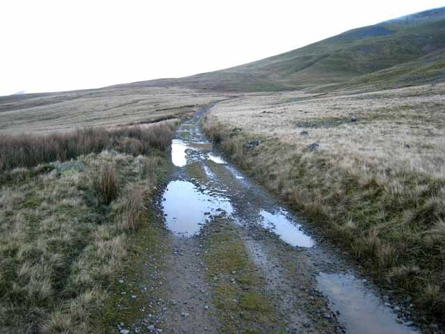The Old Coach Road below Threlkeld Knotts in the Lake District, a stony track with puddles crossing frosted moorland