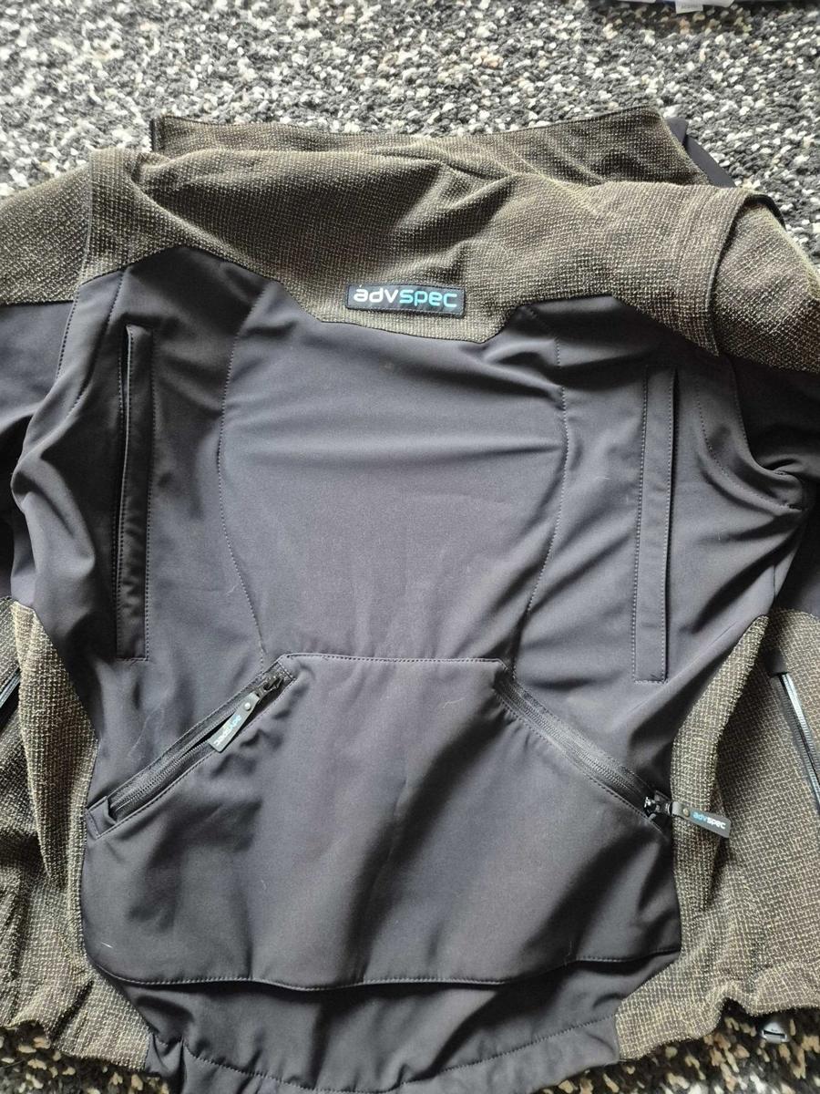 The back of the Linesman jacket laid flat, showing the zipped rear pocket