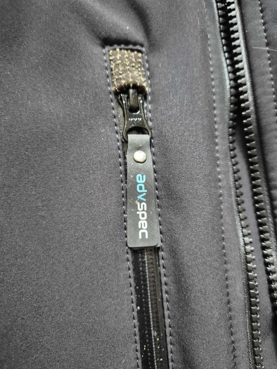 A branded advspec zip pull on the Linesman jacket's chest zip