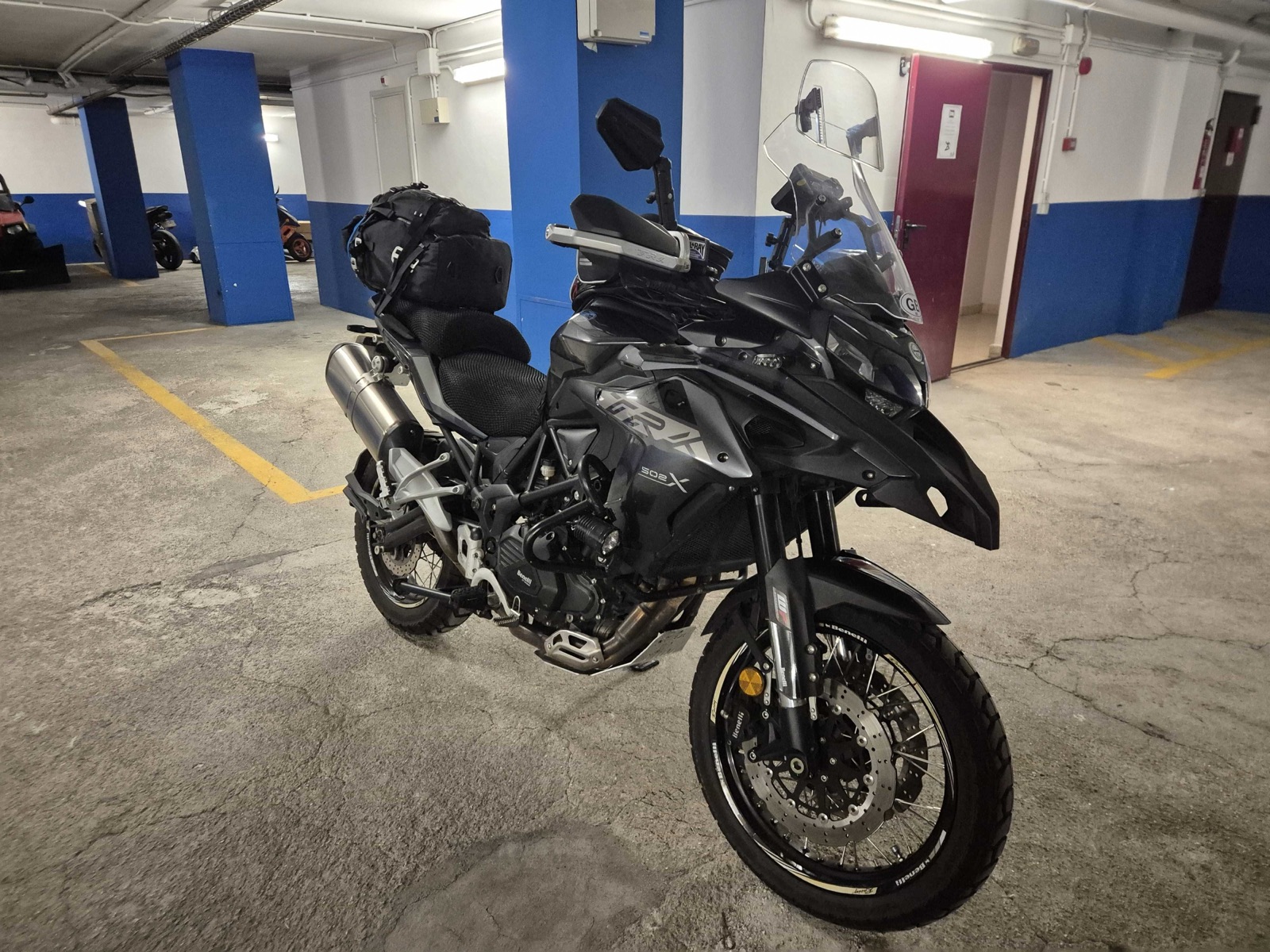 Benelli TRK 502 X front three-quarter view showing the twin front discs, spoked front wheel and crash bars