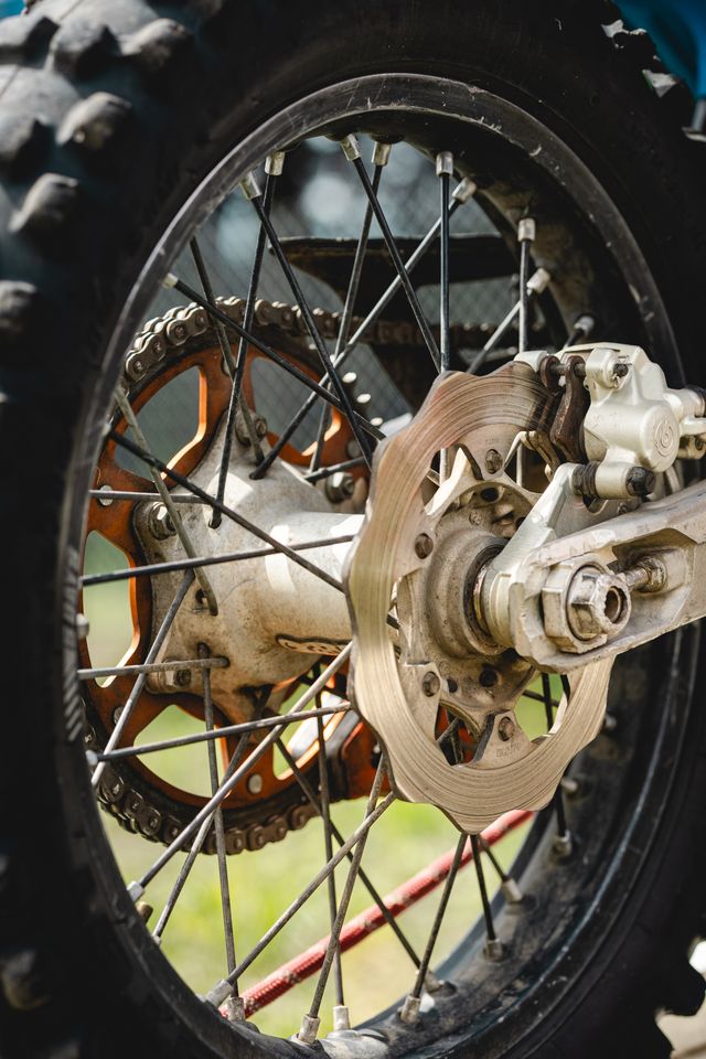 A close-up of a clean motorcycle rear sprocket, chain and brake disc