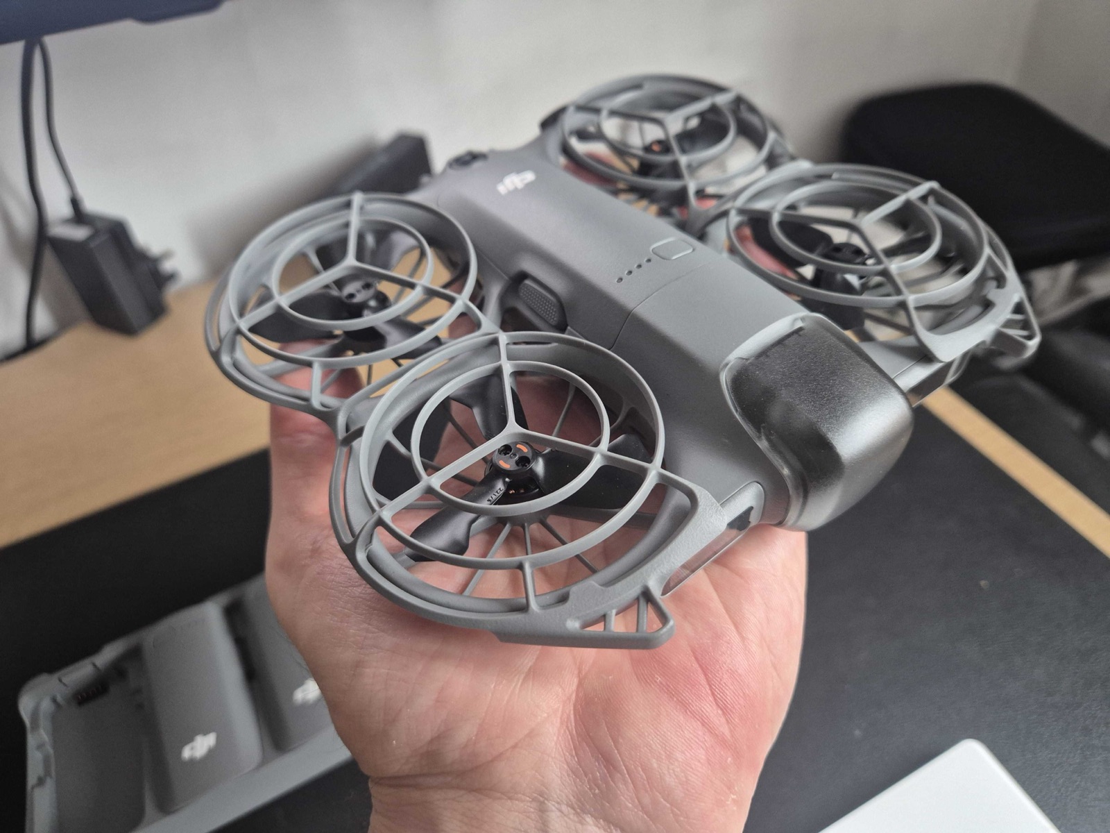 DJI Neo 2 drone held in hand, ready to launch