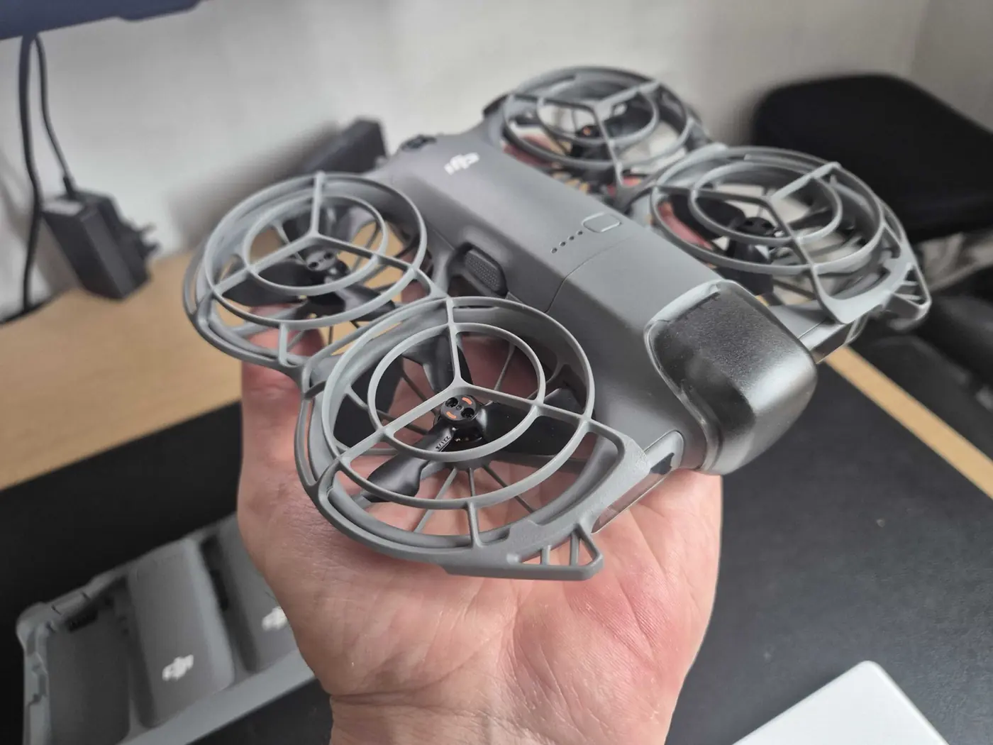 DJI Neo 2 drone held in hand, ready to launch