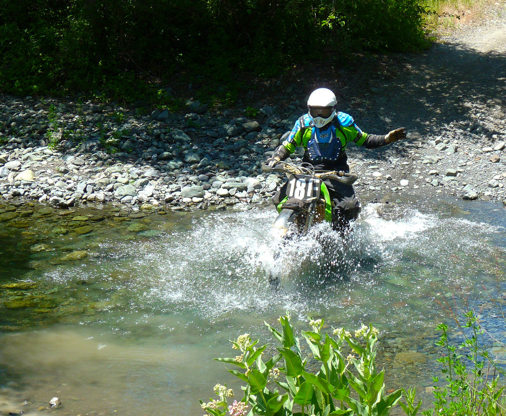 rider opening a gate on a green lane