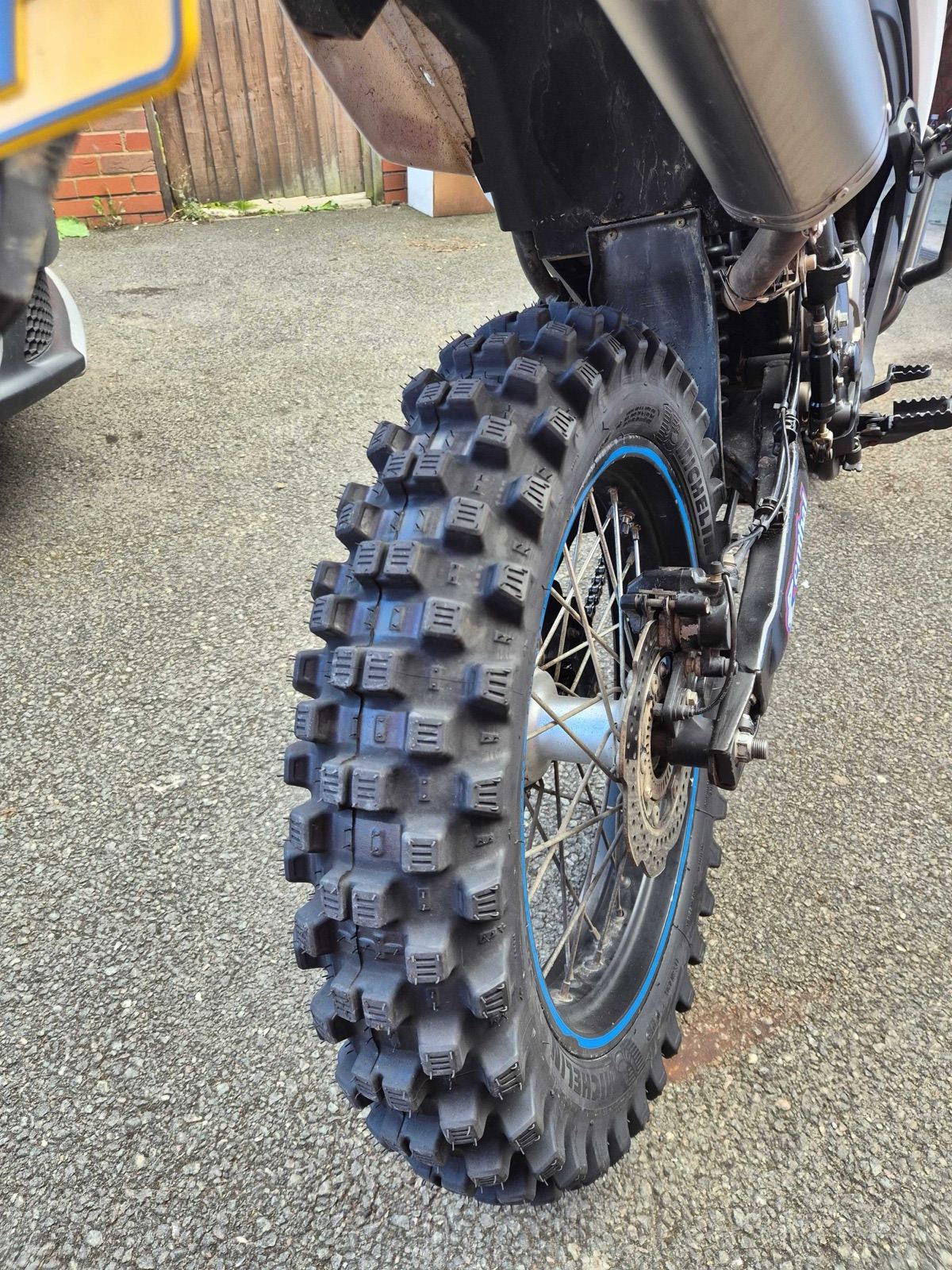 Close-up of the Michelin Tracker rear tyre on the Voge 300 Rally, showing its tall knobbly blocks