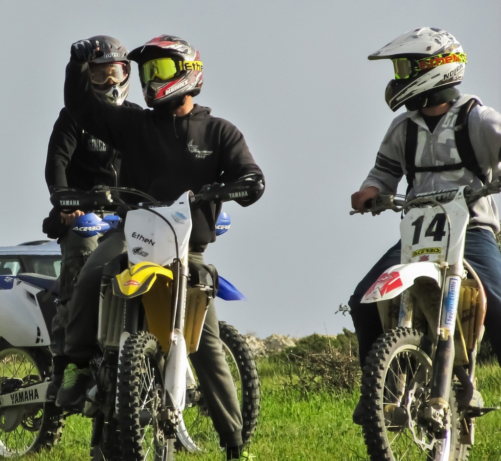 A group of riders pausing together on a green lane