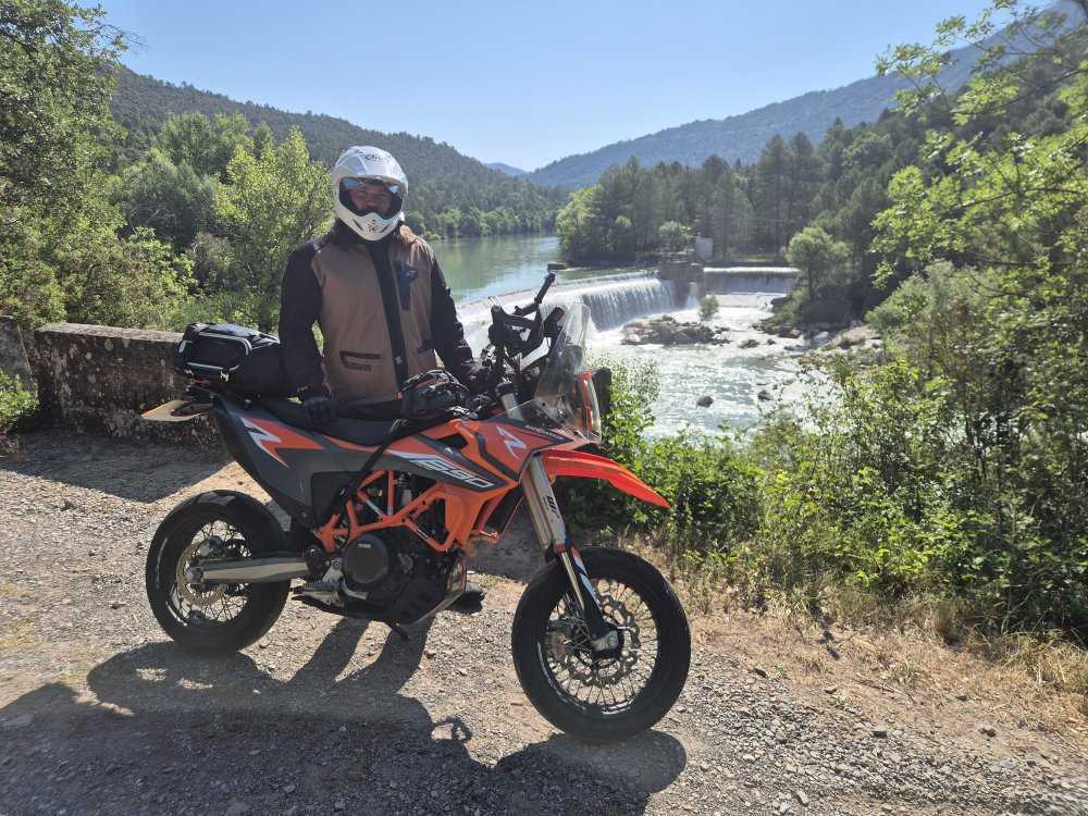 Tom's own KTM 690 Enduro R, parked up beside a river on one of his rides