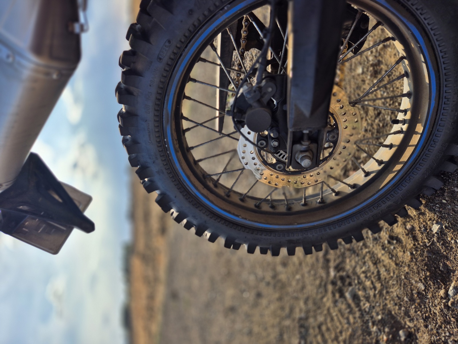 Close-up of the Voge 300 Rally's rear wheel, sprocket and exhaust tip