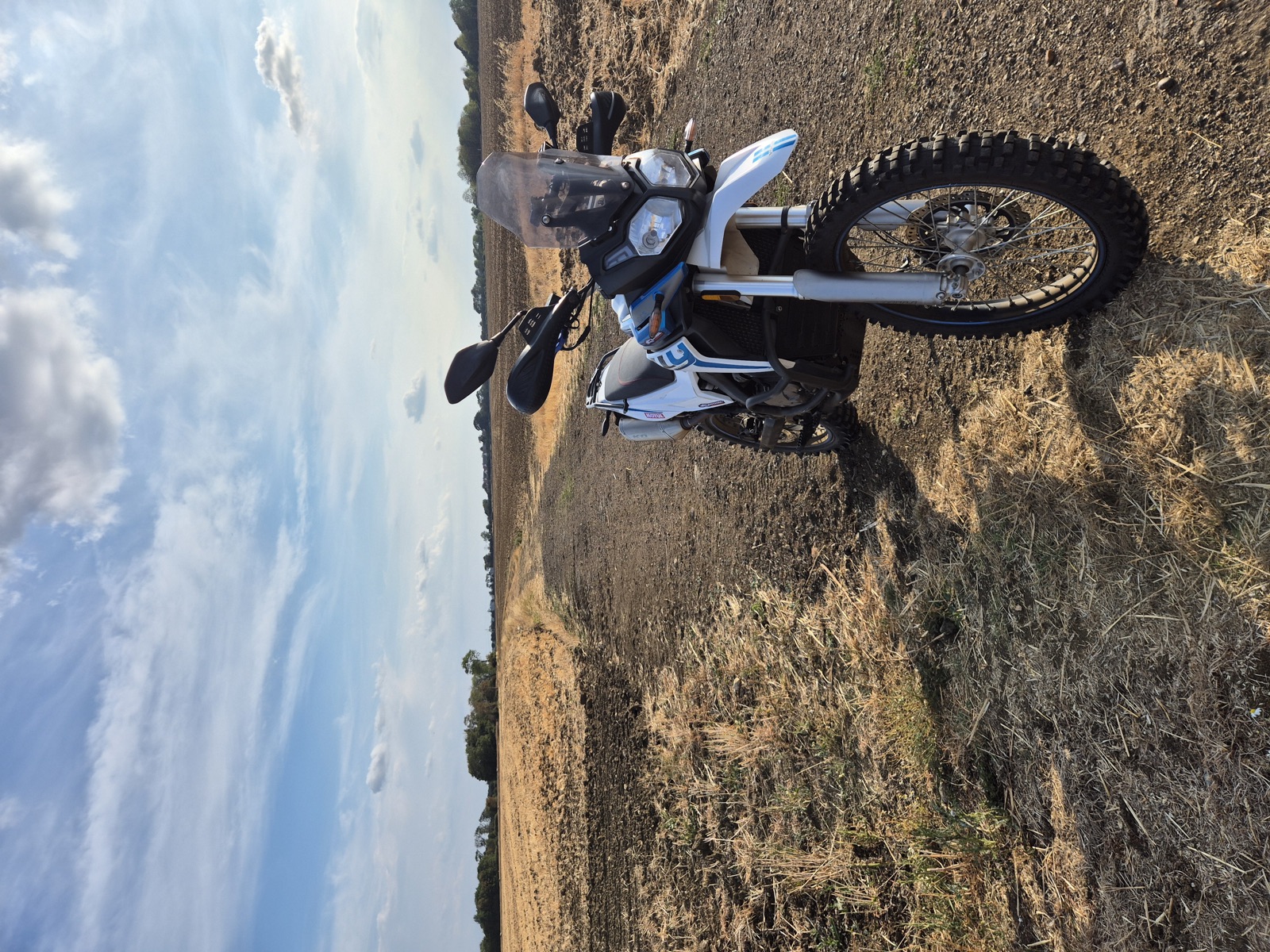 Voge 300 Rally parked on a farm track in the evening light