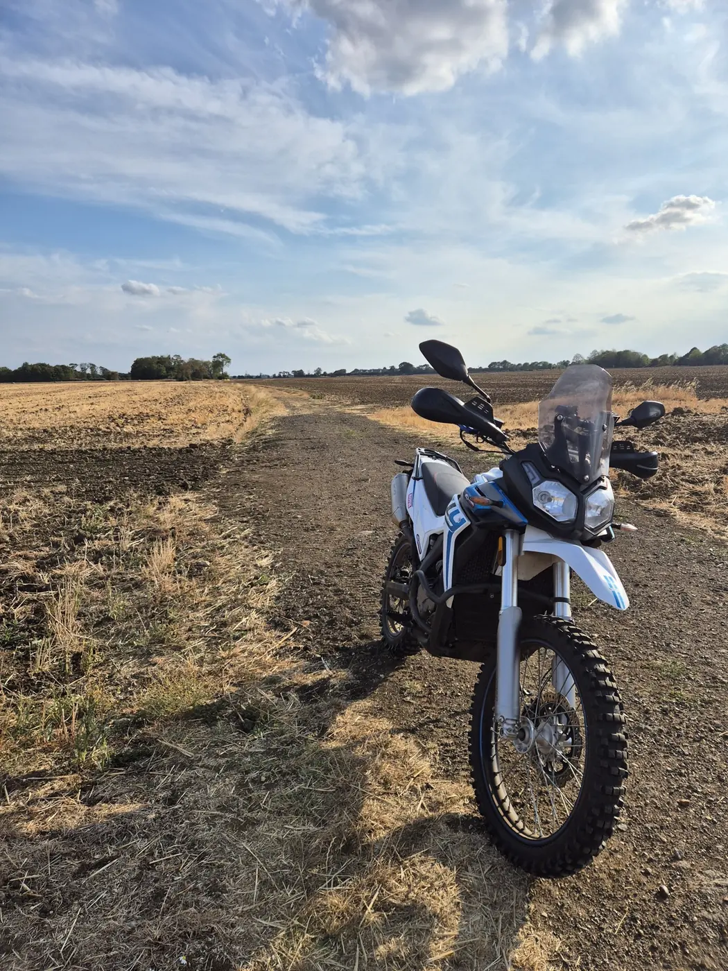 Voge 300 Rally parked on a farm track in the evening light